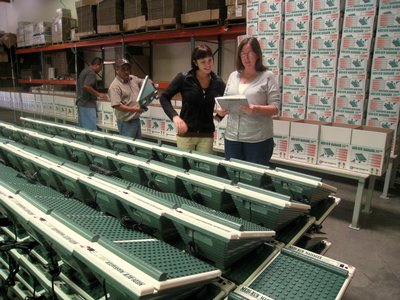 Two Women In A Warehouse Surrounded By Massagers